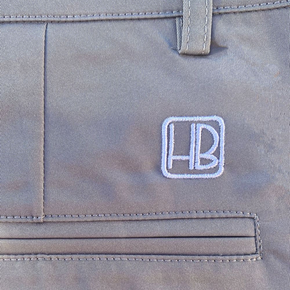 Hole Black Golf Zoom sur la poche arrière d'un pantalon et bermuda de golf gris pour fine couture