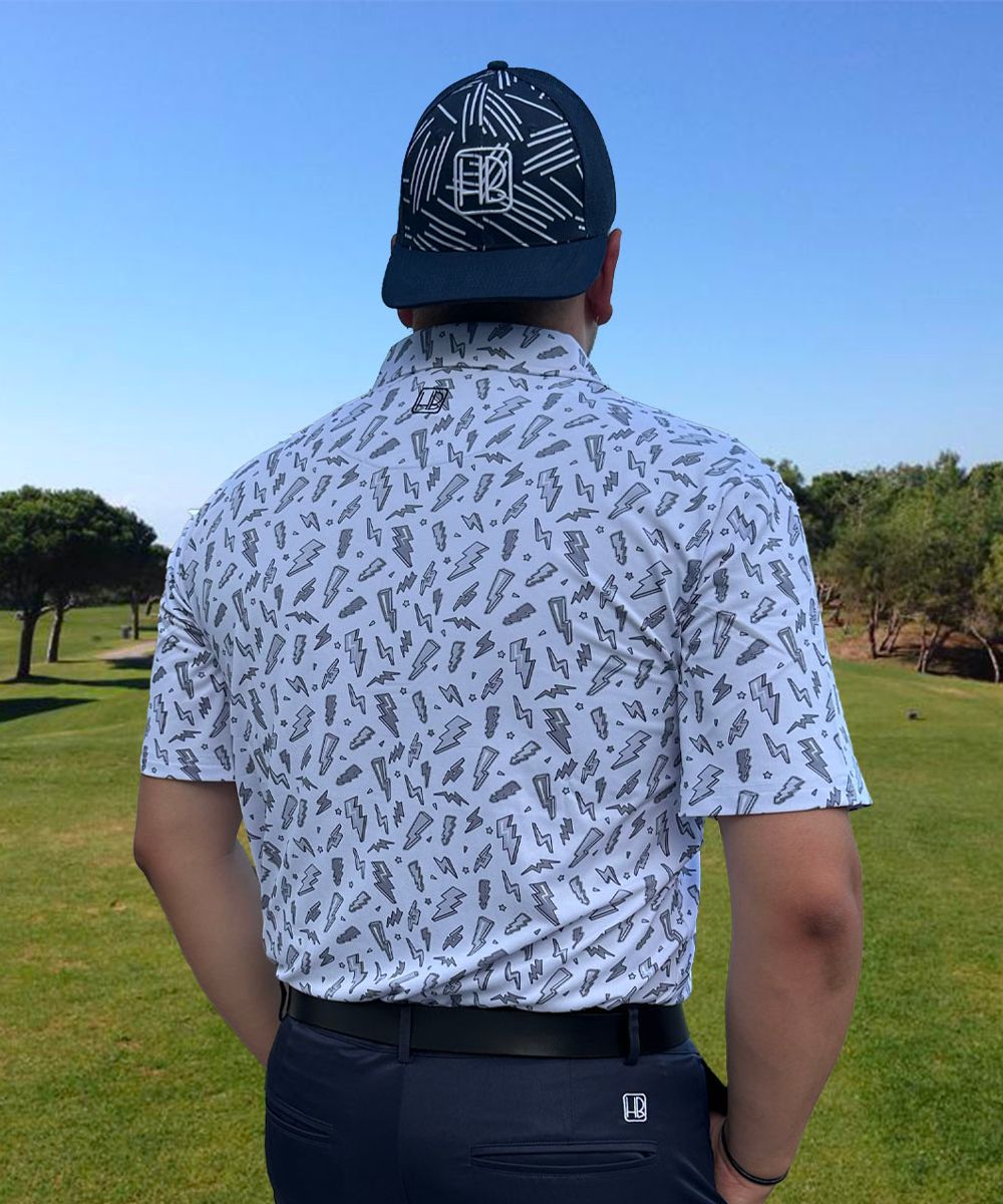 Hole Black Golf mannequin portant un pantalon de golf marine et un polo de golf blanc imprimé